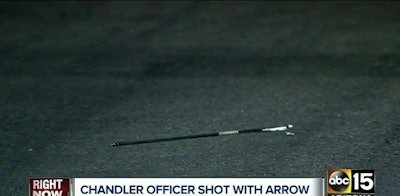 An arrow in the street at the scene where police say a Chandler, AZ, officer was shot by a suspect wielding a bow. (Photo: Screenshot from ABC15)