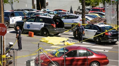 The body of a man suspected of killing three people in a San Francisco UPS facility lies in the street. He killed himself when confronted by responding officers. (Photo: Screen shot from SFGate.com video)