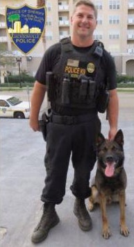 Jacksonville K-9 officer Jeremy Mason was shot in the face during the pursuit of a bank robbery suspect. The suspect was killed in a subsequent shootout. Mason is in stable condition at a local hospital. (Photo: Jacksonville SO)