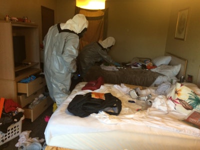 Authorities search the motel room where three Arlington, WA, officers were sickened while serving a warrant. Fentanyl is suspected. (Photo: Arlington PD/Facebook)