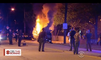 A police vehicle burns Monday night during rioting on the campus of Georgia Tech University. (Photo: Screen shot from CBS News)