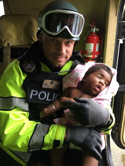 North Miami Beach officers rescued a mother and her baby Sunday from a home flooded by the storm surge of Hurricane Irma. (Photo: North Miami PD)