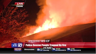 Lansing, MI, police officers rescued 15 students from this burning home early Monday morning. (Photo: WILX TV Screen Shot)