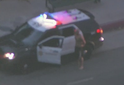 A suspect stands outside of a stolen Los Angeles County Sheriff's Department vehicle after an early morning pursuit. (Photo: ABC7 Screen Shot)