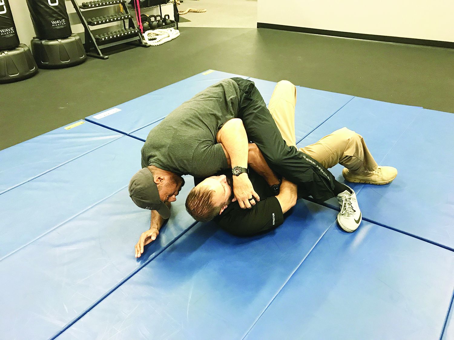 Using a modified power lock from the ground, completing the move pulls the attacker down to the ground as well. Photo: Dave Young