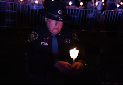 Officer honors the fallen at annual Candlelight Vigil at the National Law Enforcement Officers Memorial in Washington, DC. (Photo: Lynn Cronquist)