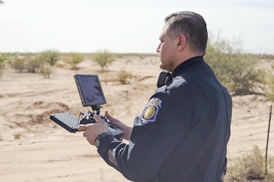 An officer is using a DJI Cendence controller with a DJI CrystalSky monitor to operate his agency's UAS, or drone. Photo: Michael Hamann