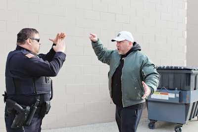 Having your hands up, in front of you using the 'emergency time out' position allows you to communicate a message of non-violent intentions without compromising officer safety. Photo: Dave Young