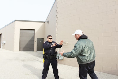Putting your two hands up as a stop sign is another way to exude a professional image while maintaining officer safety. Photo: Dave Young