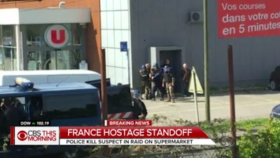 A French policeman was shot by a gunman Friday after swapping himself for a hostage in a siege at a supermarket in the southwest town of Trebes. (screenshot: CBS News)