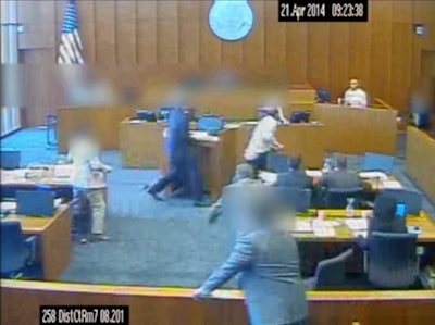 Gang member Siale Angilau charges at a witness with intent to attack him with a pen during a 2014 trial. Angilau was shot and killed by a U.S. Marshal.