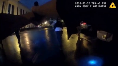 Charlotte-Mecklenburg police officers react to an attack by a murder suspect who fired on them in the parking lot of police headquarters in January.