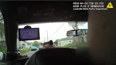 A Louisville police officer fires through his vehicle's windshield at a robbery suspect.