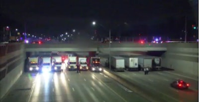 Michigan State Police used a collection of tractor-trailers trucks to prevent a man from jumping off of a freeway overpass early Tuesday. (Photo: Fox2 Detroit Screen Shot)