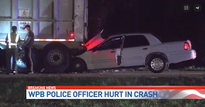 The front of the officer's unmarked police vehicle became wedged underneath the rear of the tractor trailer. Photo: CBS12 screenshot.