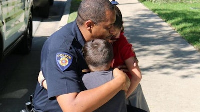 Round Rock, TX, police chief Allen Banks hug Ximena and another child during a visit. Ximena donated her allowance to Round Rock officers who are mourning the loss of Officer Charles Whites. (Photo: Round Rock PD/Facebook)