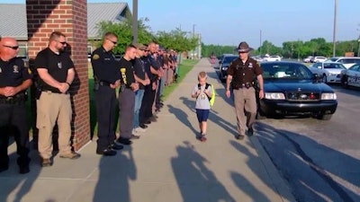 Dakota Pitts, the 5-year-old son of slain Terre Haute, IN, Officer Rob Pitts is escorted to school by his father's comrades. (Photo: WNDU screen shot)