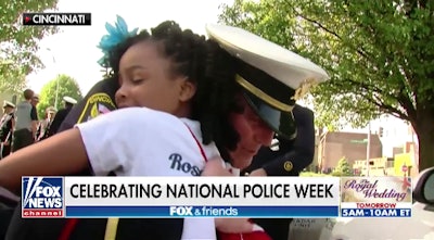 8-year-old Rosalyn Baldwin hugs an officer.