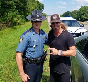 Arkansas State Trooper Deston Linkous with Brett Michaels, who was in a vehicle traveling east on Interstate 40 on Tuesday and was headed to a concert with Cheap Trick and Pop Evil that night. (Photo: Arkansas State Police)