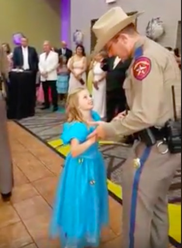 A Texas trooper dances with his daughter at an event to raise awareness of a rare cancer that killed a fellow trooper's child.