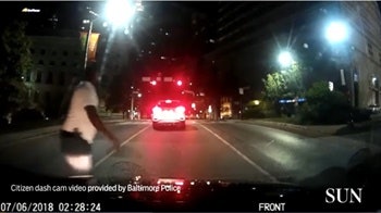 Screen grab of citizen dash-cam video of a man with a gun in Baltimore. Image courtesy of the Baltimore Sun.
