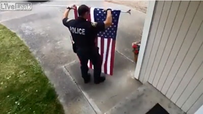 Video of a Marysville, WA, police officer picking a flag up off the ground has gone viral. (Photo: screenshot)