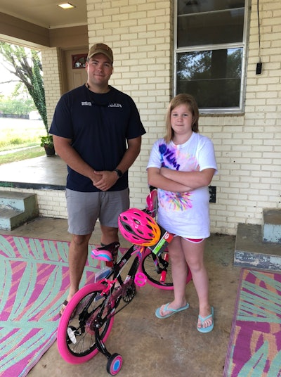 Deputy Justin Butcher of the Garland County (AR) Sheriff’s Office went 'above and beyond the call of duty' said Sheriff Mike McCormick in a Facebook post when he found a way to get a replacement bike for a little girl who had hers stolen. Image courtesy of Garland County SO / Facebook.