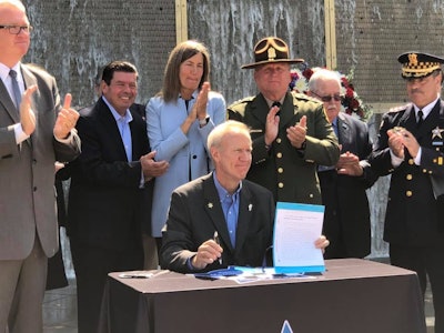 Illinois Governor Bruce Rauner signed a bill on Monday to create a new Illinois Lottery scratch-off game with the proceeds 'funding police memorials, support for the families of officers killed or severely injured in the line of duty, and protective vest replacements for officers. Image courtesy of Governor Bruce Rauner / Facebook.