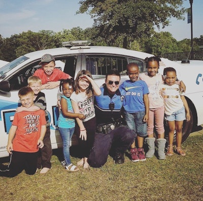 Albany, GA, Ptl. Travis Goodson with local kids.