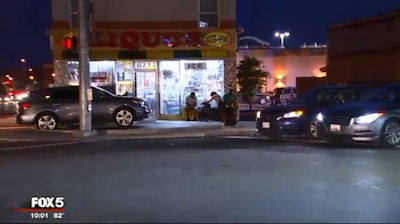 A suspect who had reportedly just shot and killed a victim at a liquor store was fatally shot by an officer who happened to be in his police vehicle right outside. Photo: Fox5-TV.