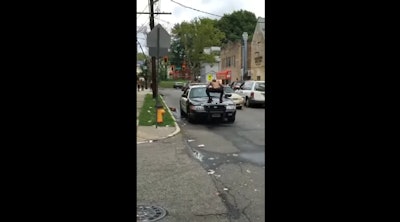 Two Newark police officers have been suspended for not taking action when a man stomped on a patrol car.