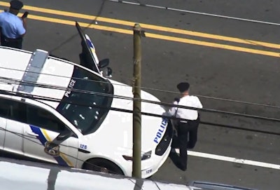 Screen grab of a video posted to Facebook of an ariel view of a Philadelphia car that was riddled with bullets in a running gun battle between a gunman on a bicycle and pursuing police on Thursday morning. Image courtesy of ABC-TV / Facebook.
