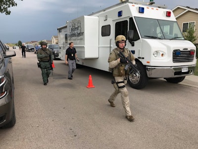 Officers rush to arrest a man who reportedly opened fire on officers and briefly held two people hostage. Image courtesy of Pennington County Sheriff's Office / Facebook.