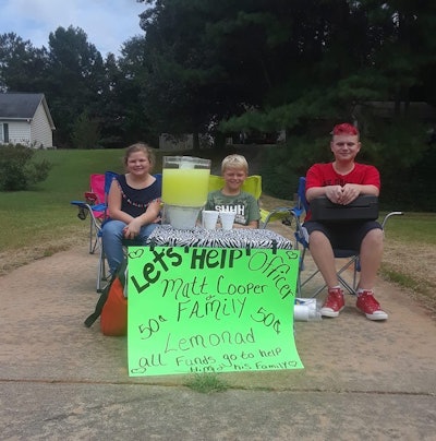 When several children living in Covington, GA, heard that one of the officers with their department had suffered a severe wound when he was shot, they wanted to do something for him and his family. So they banded together and opened up a lemonade stand. Image courtesy of Shena Chambers / Facebook.