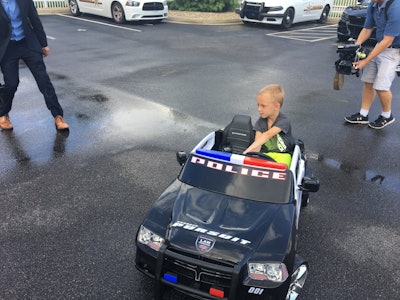 The Edinburgh Police Department, Bartholomew County Sheriff’s Office, and Stinesville Police Department surprised a heartbroken five-year-old boy with a new electric police car after his was stolen. Image courtesy of Edinburgh PD / Facebook.