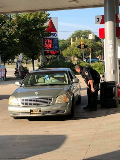 Seth Kazz—who owns and operates the Little Mack Citgo in St. Clair Shores, MI—posted a picture on Facebook of Officer Todd Bing talking with Delores Marotta, whose husband had recently passed away, and who had only three dollars for available for gasoline. Image courtesy of Seth Kazz / Facebook.