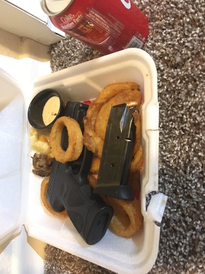 Police officers with the Gresham Police Department found a loaded semi-automatic pistol and spare magazine in a man's 'to-go' food order box. Image courtesy of Gresham PD / Twitter.