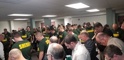 The Leon County (FL) Sheriff's Office posted a picture to Facebook showing deputies bowing their heads in prayer as they braced for the imminent landfall of Hurricane Michael on October 9, 2018. Image courtesy of Leon County SO / Facebook.