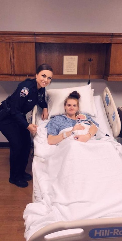 Officer Sierra Reprogal is pictured with Bridgette Crumley after she helped deliver Crumley's newborn baby girl at roadside. Image courtesy of Dickson PD / Facebook.