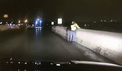 Screen grab of video showing Ohio deputy saving suicidal man from jumping off overpass.