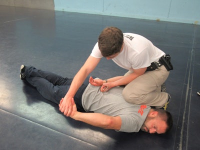 Should the arrestee begin to resist, maintain control by driving the arm downward and apply pain compliance through the wrist manipulation. That said, no tactics work every time; be aware that the control officer may need to disengage.