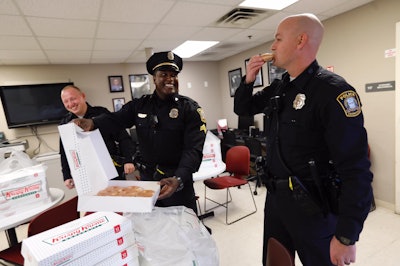 When a social media post by the Lexington (KY) Police Department—showing officers appearing to be crying after fire destroyed a Krispy Kreme Doughnuts delivery truck—went viral, the confectioner company sent a message via twitter to the agency saying that more doughnuts are 'on the way.' On Wednesday, the company delivered on its promise.