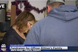 Jennifer Clark, the owner of Jen’s Sweet Treats in Cudahy, WI, takes an order for baked goods. Clark donated 100% of all proceeds Tuesday to the family of slain Milwaukee officer Matthew Rittner. (Photo: CBS58 screen shot)