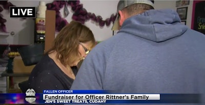 Jennifer Clark, the owner of Jen’s Sweet Treats in Cudahy, WI, takes an order for baked goods. Clark donated 100% of all proceeds Tuesday to the family of slain Milwaukee officer Matthew Rittner. (Photo: CBS58 screen shot)