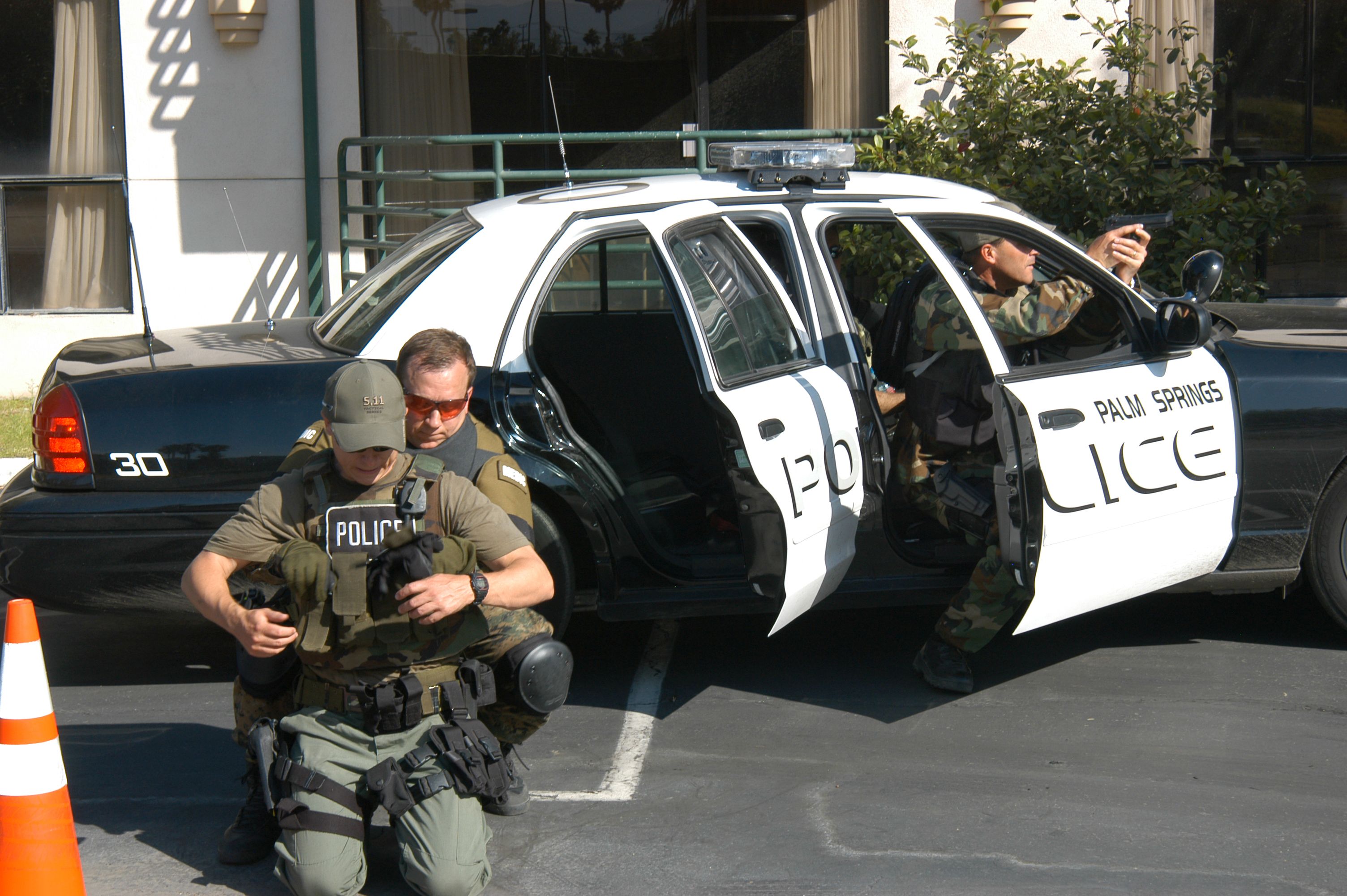 Relying on civilian EMS personnel staged far from an operation for medical aid is a thing of the past. Here, a tactical medic is shown training to rescue a downed officer.