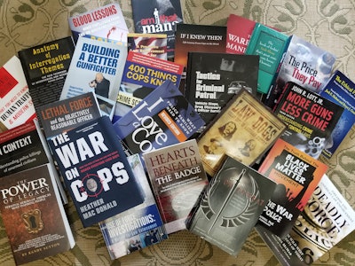 Strewn on my living room floor are a handful of books from my fairly massive collection of law enforcement books and training materials.