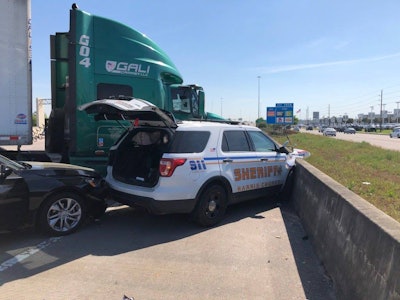A deputy with the Harris County (TX) Sheriff's Office was injured when a tractor-trailer truck struck his patrol vehicle as well as another car early Wednesday.