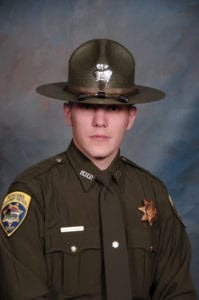 A second responding Trooper found Trooper Wade Palmer shot in his patrol vehicle with his seat belt still fastened.