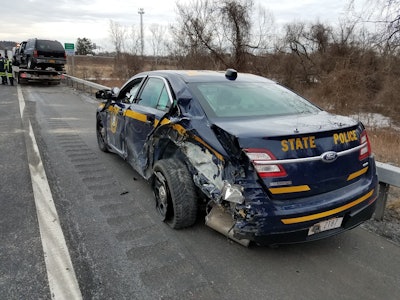 A trooper with the New York State Police suffered minor injuries when a tractor trailer truck struck his vehicle as he was assisting a disabled vehicle.