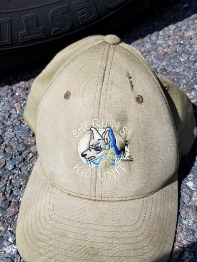 Sgt. Thomas Dane of the Volusia County (FL) Sheriff's Office was wearing this hat when he was shot with a .32 caliber handgun Thursday. The bullet punctured his K-9 baseball cap in two places and cut through his scalp. Sheriff Mike Chitwood says Dane escaped death by a millimeter. (Photo: Volusia County SO)